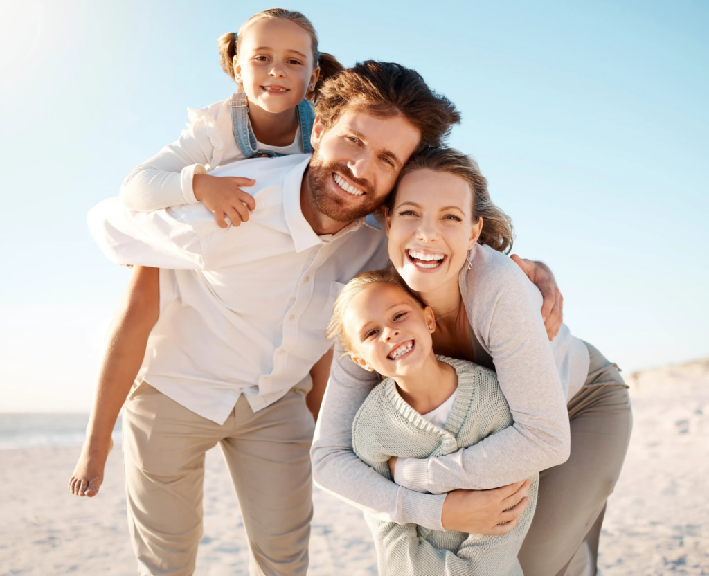 A family smiling together outdoors